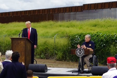 Former President Donald Trump, left, and Texas Gov. Greg Abbott, right, visit an unfinished section of border wall, in Pharr, Texas, Wednesday, June 30, 2021.