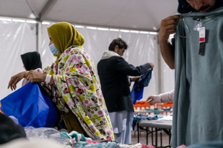 Afghan refugees pick out clothes at an Afghan refugee camp at Joint Base McGuire Dix Lakehurst, N.J., Monday, Sept. 27, 2021. The camp currently holds approximately 9,400 Afghan refugees and has a capacity to hold up to 13,000.