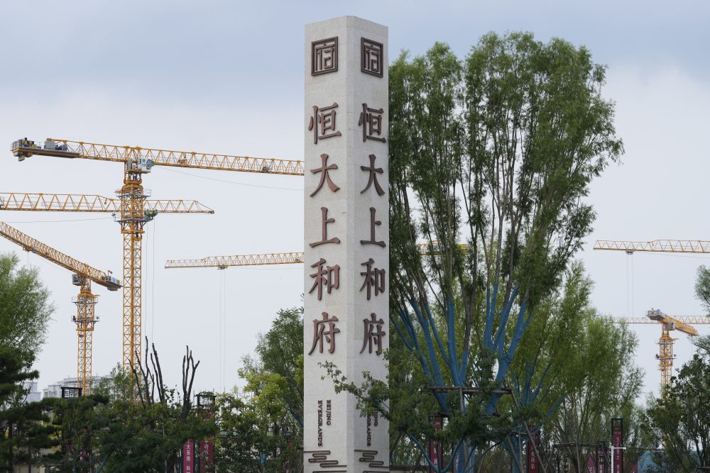 In this Sept. 15, 2021, file photo, construction cranes stand near the Evergrande's name and logo at its new housing development in Beijing. A mid-size Chinese real estate developer Fantasia Holdings Group failed to make a $205.7 million payment due to bondholders Tuesday, Oct. 5, adding to the industry's financial strain as one of China's biggest developers tries to avoid defaulting on billions of dollars of debt. Investors are worried Evergrande Group might collapse with 2 trillion yuan ($310 billion) of debt. The company has missed at least one payment to bondholders abroad but has yet to be declared in default.