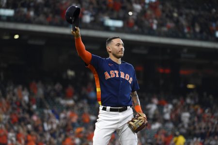 Houston Astros' Carlos Correa acknowledges the crowd after being pulled from baseball game before the ninth inning against the Oakland Athletics, Sunday, Oct. 3, 2021, in Houston.