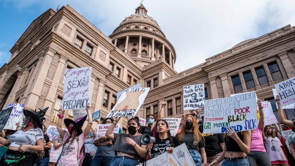 Protesters take part in the Women's March and Rally for Abortion Justice at the State Capitol in Austin, Texas, on October 2, 2021. - The abortion rights battle took to the streets across the US, with hundreds of demonstrations planned as part of a new "Women's March" aimed at countering an unprecedented conservative offensive to restrict the termination of pregnancies.