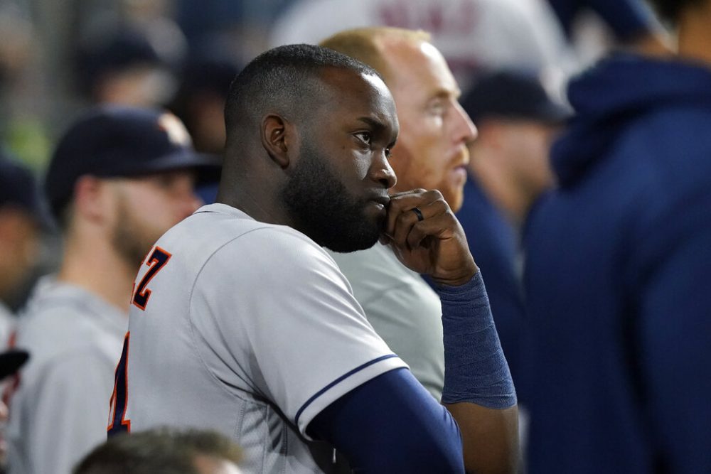 Houston Astros' Yordan Alvarez watches from the dugout against the Chicago White Sox in the eighth inning during Game 3 of a baseball American League Division Series Sunday, Oct. 10, 2021, in Chicago.