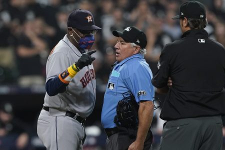 Houston Astros manager Dusty Baker Jr. (12) points to the foul line while arguing with home plate umpire Tom Hallion in the fourth inning during Game 3 of a baseball American League Division Series Sunday, Oct. 10, 2021, in Chicago.
