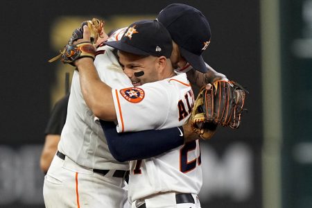 Houston Astros shortstop Carlos Correa celebrates their win with Jose Altuve against the Boston Red Sox in Game 1 of baseball's American League Championship Series Friday, Oct. 15, 2021, in Houston.