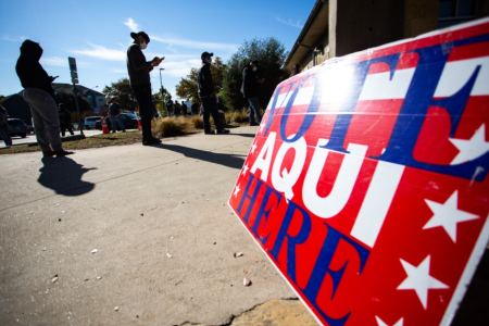 Voters wait in line at the Ruiz Branch Library in Southeast Austin in November 2020.
