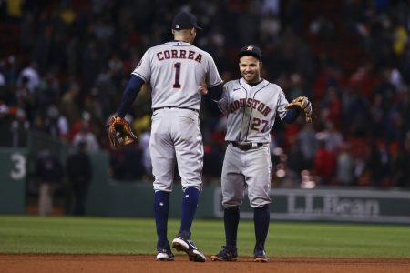 Houston Astros second baseman Jose Altuve and shortstop Carlos Correa celebrate after their win against the Boston Red Sox in Game 4 of baseball's American League Championship Series Wednesday, Oct. 20, 2021, in Boston.