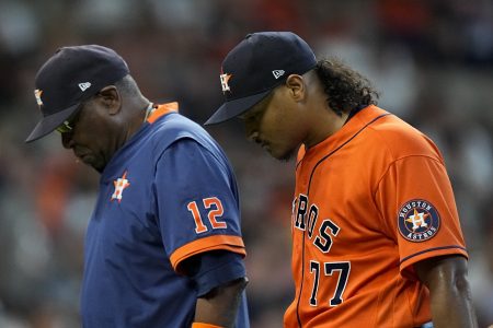 Houston Astros starting pitcher Luis Garcia leaves the games with manager Dusty Baker Jr. against the Boston Red Sox during the second inning in Game 2 of baseball's American League Championship Series Saturday, Oct. 16, 2021, in Houston.