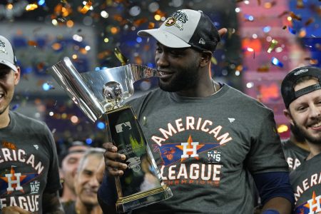 Houston Astros designated hitter Yordan Alvarez holds the trophy after their win against the Boston Red Sox in Game 6 of baseball's American League Championship Series Friday, Oct. 22, 2021, in Houston. The Astros won 5-0, to win the ALCS series in game six.