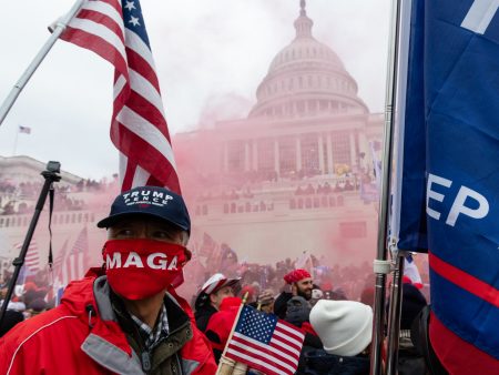 A protester unleashes a smoke grenade in front of the U.S. Capitol building during a protest in Washington, D.C., U.S., on Wednesday, Jan. 6, 2021. The U.S. Capitol was placed under lockdown and Vice President Mike Pence left the floor of Congress as hundreds of protesters swarmed past barricades surrounding the building where lawmakers were debating Joe Biden's victory in the Electoral College.