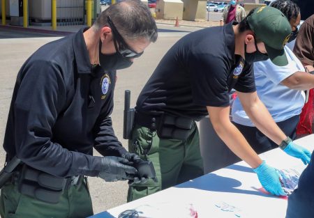 Officials help process and log personal items from migrants entering the Central Processing Center in El Paso, Texas, in this May 4 photo provided by the U.S. Border Patrol.