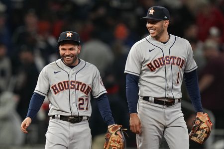 Houston Astros second baseman Jose Altuve and shortstop Carlos Correa email after their win in Game 5 of baseball's World Series between the Houston Astros and the Atlanta Braves Monday, Nov. 1, 2021, in Atlanta. The Astros won 9-5. The Braves lead the series 3-2 games.