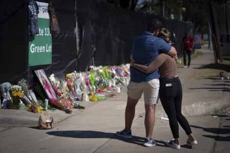 Two people who knew an unidentified victim of a fatal incident at the Houston Astroworld concert embrace at a memorial on Sunday, November 7, 2021.
