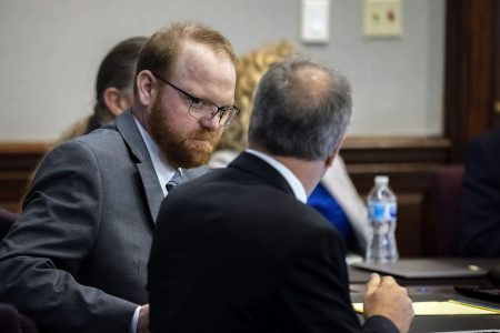 Defendant Travis McMichael speaks with his attorney Bob Rubin while they wait for the jury to return to the courtroom during the trial of McMichel and his father, Greg McMichael, and a neighbor, William "Roddie" Bryan in the Glynn County Courthouse, Wednesday, Nov. 24, 2021, in Brunswick, Ga.