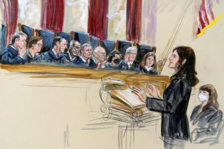 This artist sketch depicts Center for Reproductive Rights Litigation Director Julie Rikelman speaking to the Supreme Court, Wednesday, Dec. 1, 2021, in Washington. Seated to Rikelman's right is Solicitor General Elizabeth Prelogar.  Justices seated from left are Associate Justice Brett Kavanaugh, Associate Justice Elena Kagan, Associate Justice Samuel Alito, Associate Justice Clarence Thomas, Chief Justice John Roberts, Associate Justice Stephen Breyer, Associate Justice Sonia Sotomayor, Associate Justice Neil Gorsuch and Associate Justice Amy Coney Barrett.