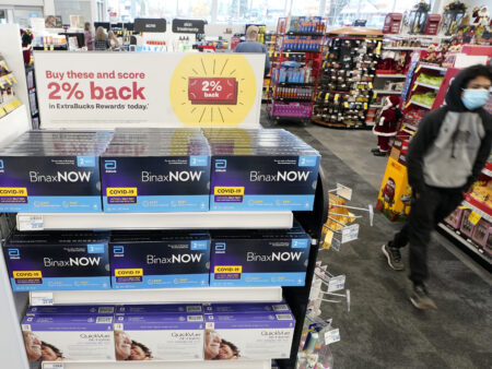 Boxes of BinaxNow home COVID-19 tests made by Abbott and QuickVue home tests made by Quidel are shown for sale Monday, Nov. 15, 2021, at a CVS store in Lakewood, Wash., south of Seattle. After weeks of shortages, retailers like CVS say they now have ample supplies of rapid COVID-19 test kits, but experts are bracing to see whether it will be enough as Americans gather for Thanksgiving and new outbreaks spark across the Northern and Western states.