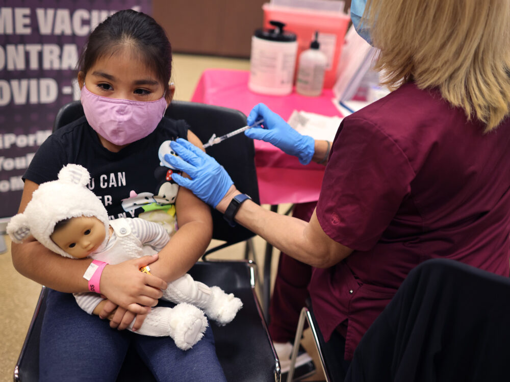 CHICAGO, ILLINOIS - NOVEMBER 12: First grade student, seven-year-old Rihanna Chihuaque, receives a covid-19 vaccine at Arturo Velasquez Institute on November 12, 2021 in Chicago, Illinois. The city of Chicago closed all public schools today, declaring the day Vaccination Awareness Day, with the hope of getting as many students as possible vaccinated against COVID-19. 