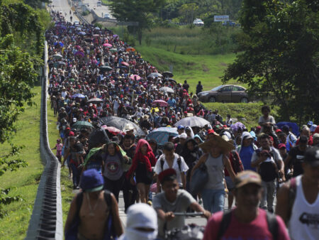 FILE - Migrants arrive in Villa Comaltitlan, Chiapas state, Mexico, Oct. 27, 2021, as they continue their journey through Mexico to the U.S. border. The Biden administration struck agreement with Mexico to reinstate a Trump-era border policy next week that forces asylum-seekers to wait in Mexico for hearings in U.S. immigration court, U.S. officials said Thursday.