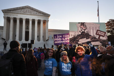 Activists and demonstrators gather in front of the U.S. Supreme Court as the justices hear arguments in Dobbs v. Jackson Women's Health.