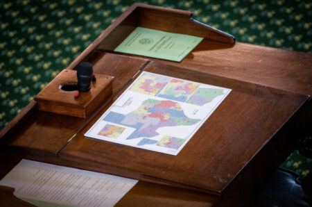 Proposed voting district maps sit on the desks of Texas legislators during the third special session Sept. 20.