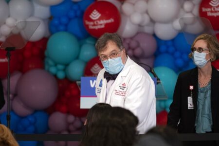 Dr. Peter Hotez finds his seat before first lady Jill Biden speaks about pediatric COVID-19 vaccines in Texas Children's Hospital Sunday, Nov. 14, 2021, in Houston.