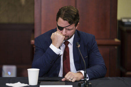 Rep. Dan Crenshaw, R-Texas, a former Navy SEAL who was wounded in Afghanistan, pauses during a roundtable discussion with House Minority Leader Kevin McCarthy, R-Calif., and other Republicans as they criticize President Joe Biden on the Afghanistan evacuation, at the Capitol in Washington, Monday, Aug. 30, 2021. (AP Photo/J. Scott Applewhite)