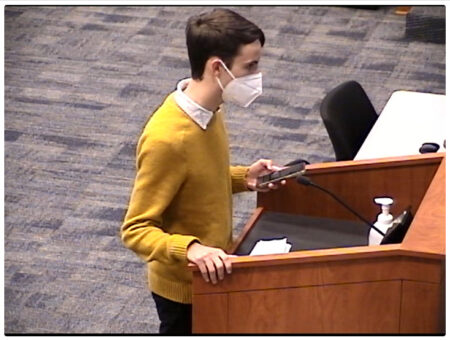 A student, Cameron Samuels, stands out a podium at a Katy Independent School District board of trustees meeting on Dec. 14, 2021. He was speaking out against the school's LGBTQ website ban.