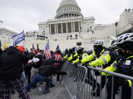 Insurrectionists loyal to President Donald Trump try to break through a police barrier at the Capitol in Washington on Jan. 6, 2021.