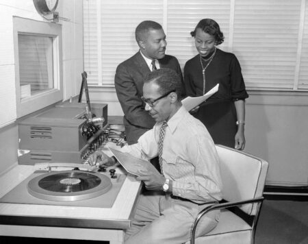 Employees go about their work in Americas only black-run radio station, WERD in Atlanta, Dec. 3, 1956. They are Jimmy Whittington (seated), staff announcer; J.B. Blayton Jr., general manager, and Margaret Ross, secretary.  (AP Photo/Atlanta Journal-Constitution) No Sales