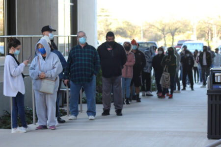 At least 130 people wait in line at the Alamo Colleges District headquarters COVID-19 testing site on Jan. 6, 2022. Texans are seeing long wait times and delayed results amid a post-holiday surge in test demand.