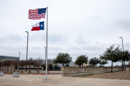 The Texas and American flag fly on a windy February morning at Zan Wesley Holmes Jr. Middle School in southwest Dallas.