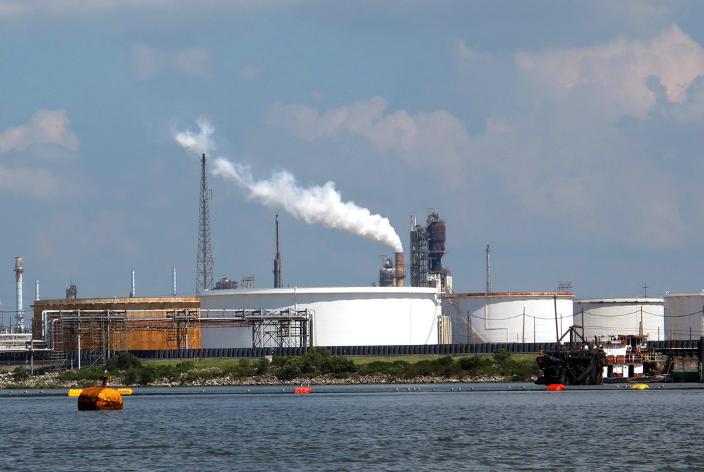 This Friday, Oct. 13, 2017, photo taken from upper Galveston Bay shows the Exxon Mobil Baytown refinery and chemical plant in Baytown, Texas. On Tuesday, Oct. 31, 2017, federal officials said that Exxon Mobil settled violations of the clean-air law with the Trump administration by agreeing to pay a $2.5 million civil penalty and spend $300 million on pollution-control technology at plants along the Gulf Coast. The plants are in Baytown, Beaumont and Mont Belvieu, Texas, and Baton Rouge, Louisiana. As part of the settlement, Exxon will spend $1 million to plant trees in Baytown.