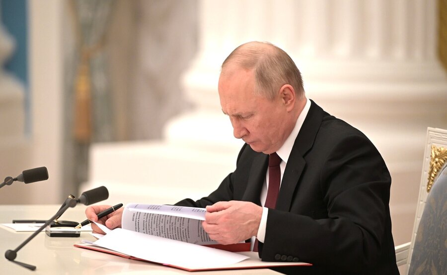 Russian President Vladimir Putin signs decrees recognizing the self-proclaimed Donetsk People's Republic and the Luhansk People's Republic in Moscow on Monday.