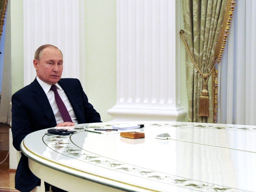Russian President Vladimir Putin speaks to German Chancellor Olaf Scholz at the Kremlin in Moscow on Feb. 15.