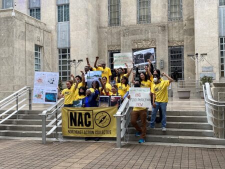 Members of the Northeast Action Collective gathered in front of City Hall to demand better drainage in their neighborhoods.