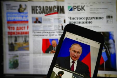 The app of the Russian government newspaper is displayed on an iPhone screen showing Russian President Vladimir Putin during his speech in the Kremlin in Moscow, Russia, Tuesday, Feb. 22, 2022. As the West sounds the alarm about the Kremlin ordering troops into eastern Ukraine and decries an invasion, Russian state media paints a completely different picture. It portrays the move as Moscow coming to the rescue of war-torn areas tormented by Ukraine’s aggression and bringing them much-needed peace.