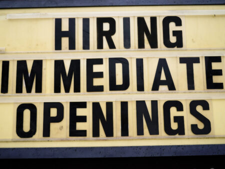 A hiring sign is posted outside business in Huntingdon Valley, Pa., Tuesday, Feb. 22, 2022.