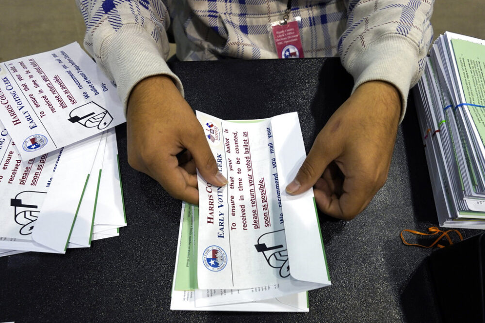 In this Sept. 29, 2020, file photo, Harris County Election Worker Jose Vasquez prepares mail-in ballots to be mailed to voters in Houston. Republicans want to make that harder, potentially affecting the voting preferences of millions of Americans in future elections. Republicans' campaign to impose new restrictions on mail-in and early voting in certain states will force voters to grapple with new rules governing popular and time-tested methods of voting.