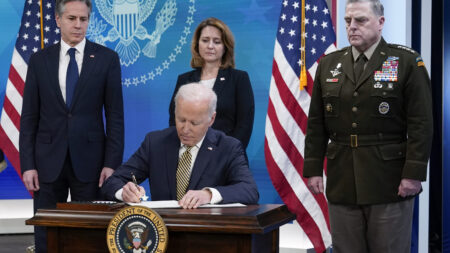 President Joe Biden signs a delegation of authority on Wednesday. From left, Secretary of State Antony Blinken, Biden, Deputy Secretary of Defense Kathleen Hicks and Chairman of the Joint Chiefs of Staff General Mark Milley.