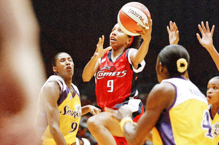 Houston Comets forward Janeth Arcain (9) drives for the basket past Los Angeles Sparks Lisa Leslie (9) and Mwadi Mabika (4) in the first half of their WNBA game at the Forum in Inglewood, California, Sunday, June 21, 1998.