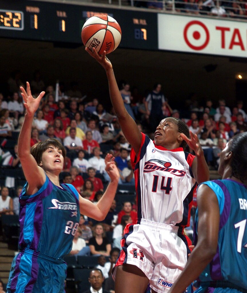 Houston Comets' Cynthia Cooper (14) goes up for a layup between Utah Starzz defenders Elena Baranova (28) and Cindy Brown (15)  in this Aug. 16, 1999 file photo in Houston. One of 16 players who formed the core of the WNBA a decade ago, Cooper closed out her career in 2003 as one of the grand dames of the game and is among the leading candidates for the WNBA's All-Decade Team.