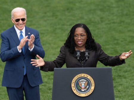 Judge Ketanji Brown Jackson speaks as President Joe Biden reacts at an event celebrating Jackson's confirmation to the Supreme Court on the South Lawn of the White House on April 8, 2022.