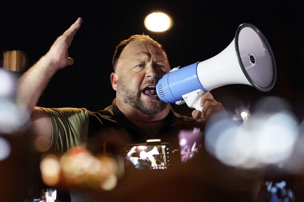 FILE — Infowars host and conspiracy theorist Alex Jones rallies pro-Trump supporters outside the Maricopa County Recorder's Office, Nov. 5, 2020, in Phoenix. Jones has agreed to appear at a deposition in Connecticut to answer questions in a lawsuit by relatives of some of the Sandy Hook Elementary School shooting victims, his lawyers said Thursday, March 31, 2022, a day after a judge ordered fines against Jones for defying orders to attend a deposition last week despite his claim of illness.