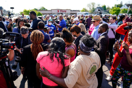People gather outside the scene of a shooting at a supermarket, in Buffalo, N.Y., Sunday, May 15, 2022.