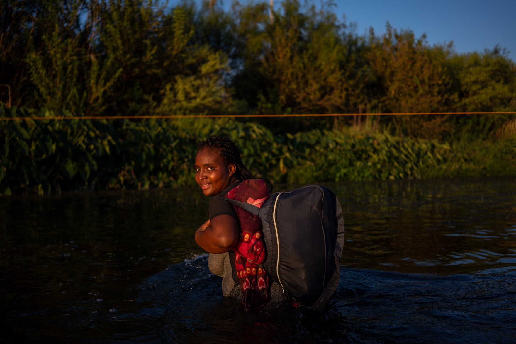 Dachka, 24, crosses the Rio Grande after leaving the camp under the Del Rio International Bridge on Sept. 20, 2021. She said she feared being deported back to Haiti.