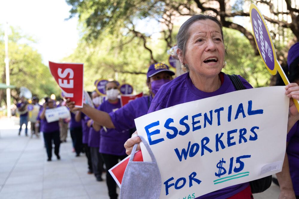 Houston janitors protest for a $15 minimum wage near City Hall on May 18, 2022. 