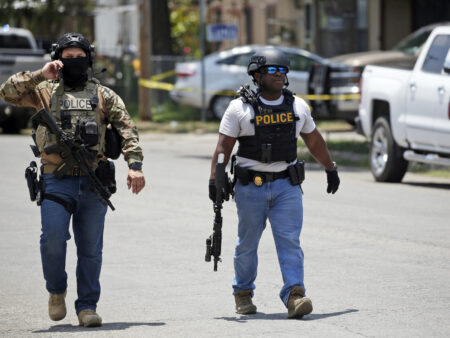 Police walk near Robb Elementary School following a shooting, Tuesday, May 24, 2022, in Uvalde, Texas. (AP Photo/Dario Lopez-Mills)