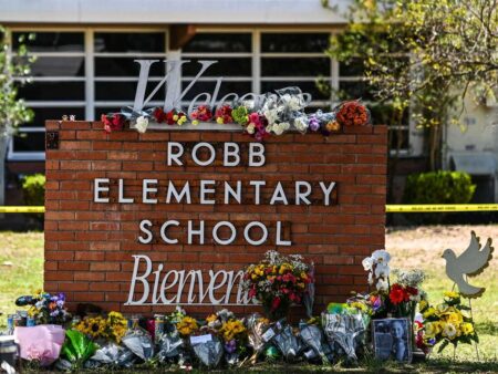 Flowers are placed on a makeshift memorial in front of Robb Elementary School in Uvalde, Texas, on May 25, 2022. - The tight-knit Latino community of Uvalde was wracked with grief Wednesday after a teen in body armor marched into the school and killed 19 children and two teachers, in the latest spasm of deadly gun violence in the US. (Photo by CHANDAN KHANNA / AFP) (Photo by CHANDAN KHANNA/AFP via Getty Images)