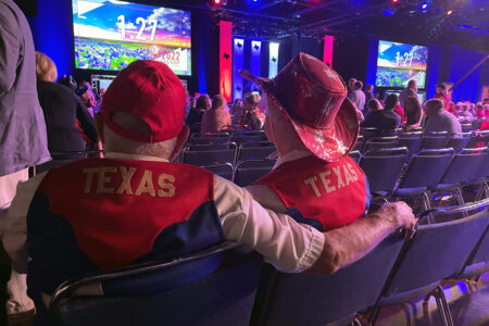 Two Texas Republicans sit inside the state GOP convention on June 17, 2022, at the George R. Brown Convention Center in downtown Houston.