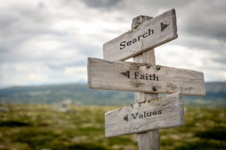 search faith values text on wooden signpost outdoors in landscape scenery.