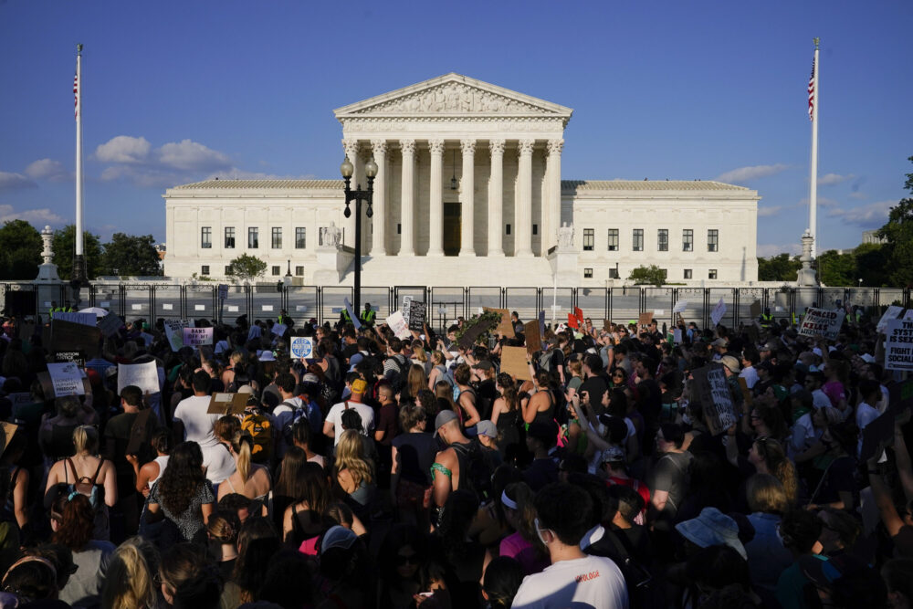 Protesters fill the street in front of the Supreme Court after the court's decision to overturn Roe v. Wade in Washington, June 24, 2022. Public opinion on abortion is nuanced, but polling shows broad support for Roe and for abortion rights. Seventy percent of U.S. adults said in a May AP-NORC poll that the Supreme Court should leave Roe as is, not overturn it.